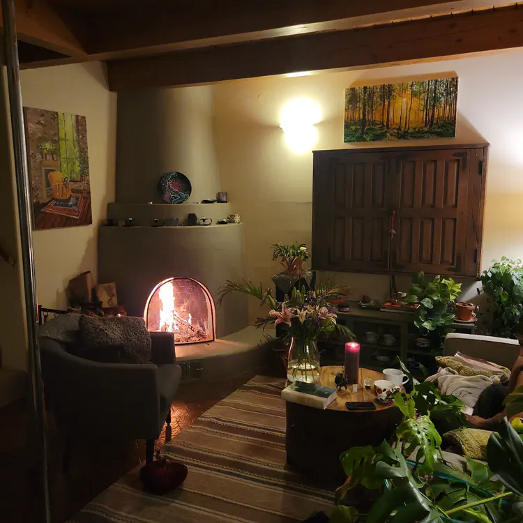 Cozy living room with fire in the kiva fireplace.
