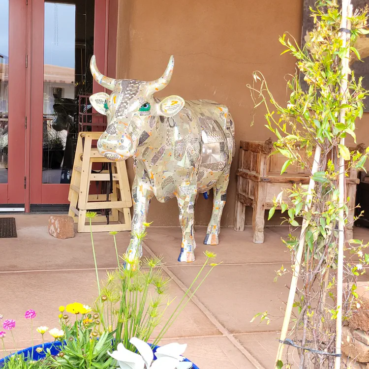 Cow at restaurant entrance.